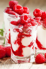 Raspberry ice cream with berries and mint, served in glasses on