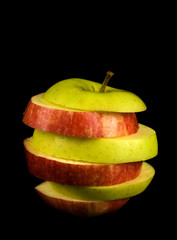 Fototapeta na wymiar sliced red and green apple isolated on black