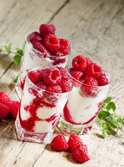 Raspberry ice cream with berries and mint, served in glasses on