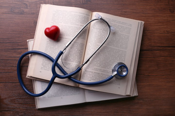 Stethoscope on books on wooden background