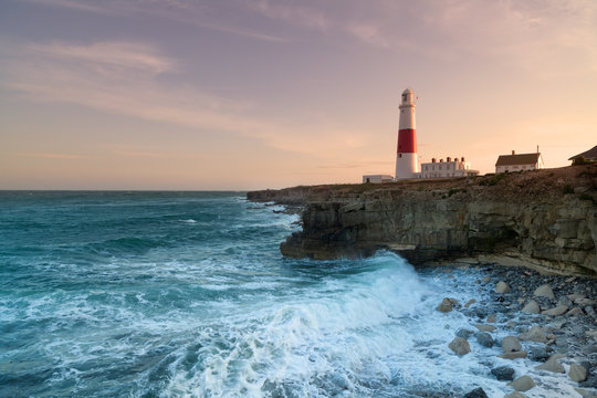 Stormy seas crash over the rocks with the lighthouse in the background at Portland Bill in Dorset.Stormy seas crash over the rocks with the lighthouse in the background at Portland Bill in Dorset.