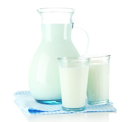 Pitcher and glasses of milk, isolated on white