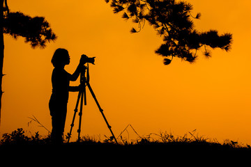 .Silhouette photographers take camera landscape