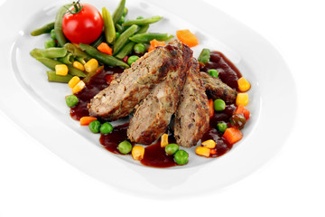 Tasty slices of meat with vegetables on plate isolated on white