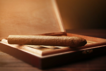 Cigars on wooden table, closeup