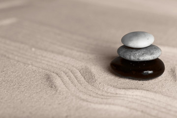 Fototapeta na wymiar Zen garden with stones on sand background