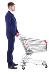 Young man with empty shopping cart, isolated on white