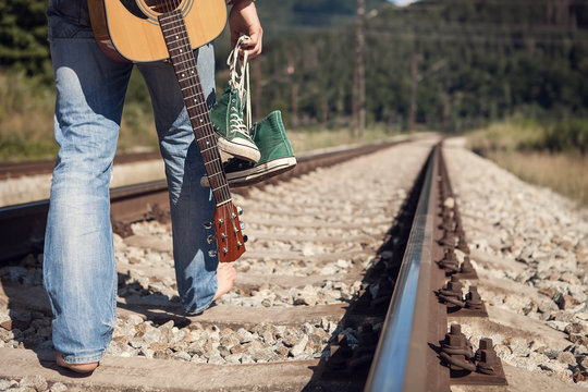 Alone traveler barefoot walk on the railway