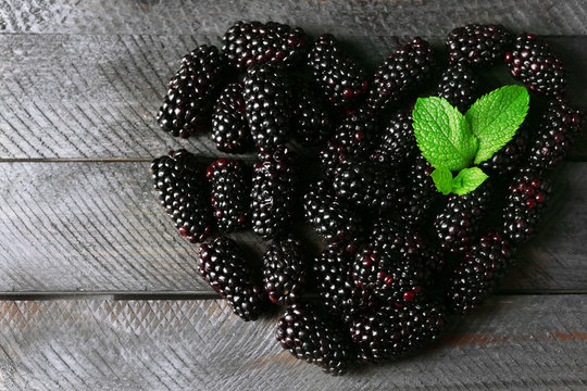 Ripe blackberry on wooden background