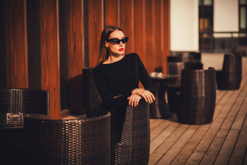 Glamorous portrait of a stylish woman in a cafe.