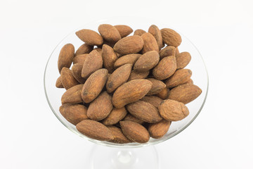 Almonds in glass with isolated background.