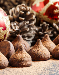 Chocolate truffles, sprinkled with cocoa powder, red Christmas b