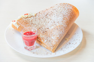 Crepe dessert with strawberry fruit and whipping cream