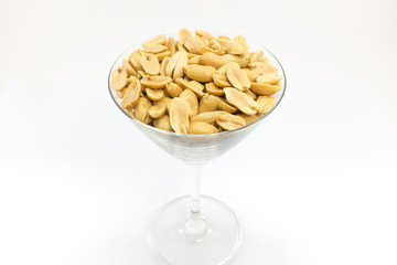 Processed peanuts in glass with isolated background.