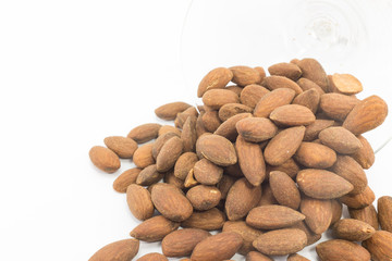 Almonds with glass on isolated background.