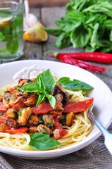 pasta with mussels, pepperoni, bacon, tomato and basil