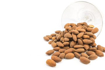 Almonds with glass on isolated background.