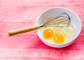 preparing omelet with eegs and whisk