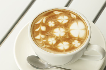 Hot latte coffee decorated on white background, latte art.