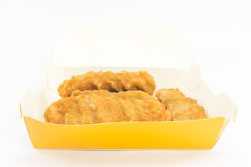 Fried chicken in paper box on isolated background.