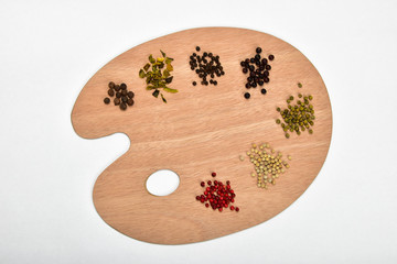 Fototapeta na wymiar Palette of various spices on wooden palette isolated on white