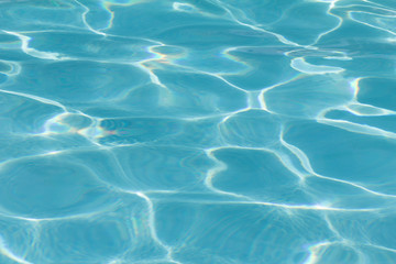 Blue pool water with sun reflections