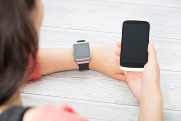 Woman holding and touch smart watch.