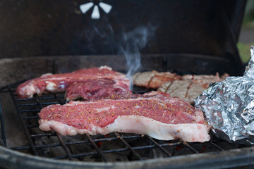 T-Bone Steaks smoking on Charcoal Grill