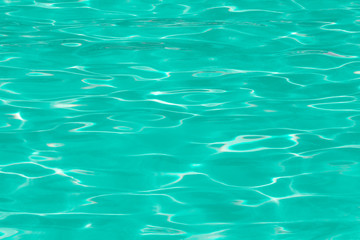 green pool water with sun reflections