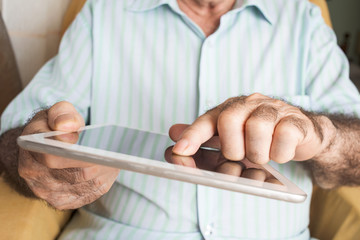 old man using a tablet computer