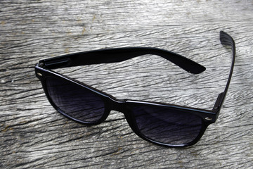 black eye glasses on wood background