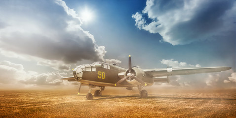 Old bomber in cloud of dust in the open field