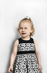 Little Girl in black and white dress standing