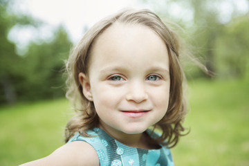 Adorable little girl in the forest meadow