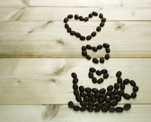 Coffee beans in shape of a heart, on old vintage wooden backgrou