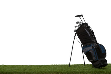 Golf bag and clubs on grass isolated on white