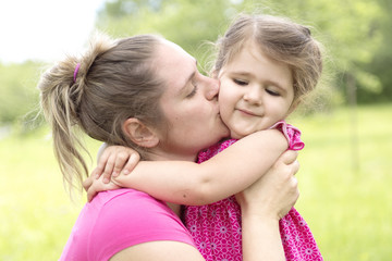 Mother and daughter in forest on a meadow