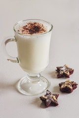 Milk cocktail with chocolate cookies on table close-up
