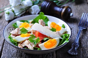 salad with tuna, tomatoes, boiled eggs and parmesan cheese