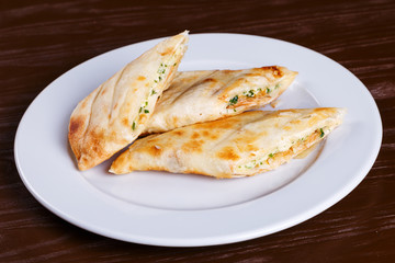 Pieces of pie with cheese on a wooden board