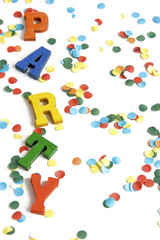 Wooden letters spelling party, on white background with confetti
