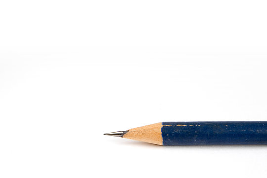 old blue pencil laying on white background