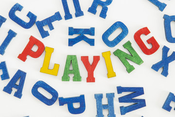 Series activities: Word "playing" in colorful letters on white background
