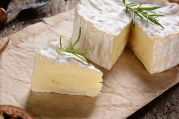 Camembert cheese on a rustic background