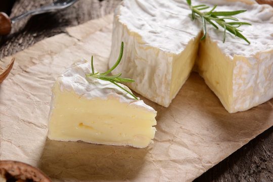 Camembert cheese on a rustic background