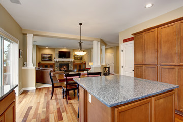 Classic kitchen with island and stainless steel fridge.