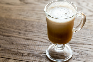 Glass mug with cappuccino