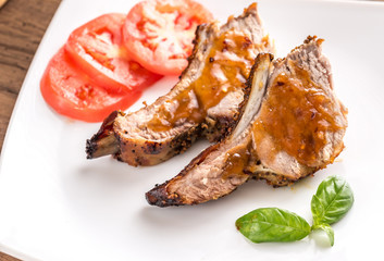 Portion of grilled pork ribs in barbecue sauce
