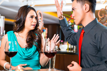 Asian couple sitting in restaurant