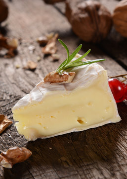 Camembert cheese on a rustic background